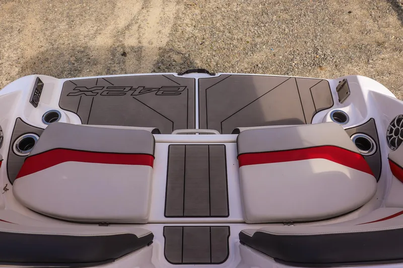Slide: The Image of 2019 Yamaha Boats 242X E-Series swim platform with cushioned seating and cup holders. - 25