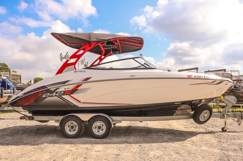 Slide: The Image of 2019 Yamaha Boats 242X E-Series on trailer under blue sky. - 3