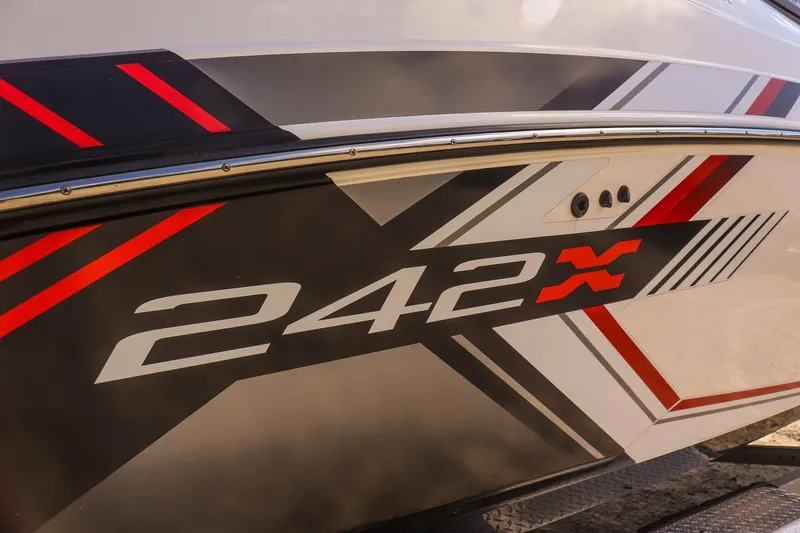 Slide: The Image of 2019 Yamaha Boats 242X E-Series side view with bold graphics and logo. - 30