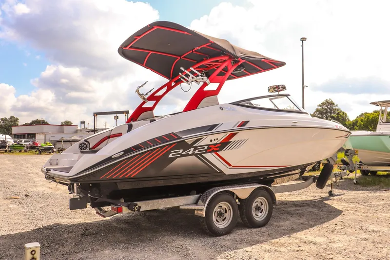 Slide: The Image of 2019 Yamaha Boats 242X E-Series on trailer, featuring sleek design and vibrant red accents. - 4