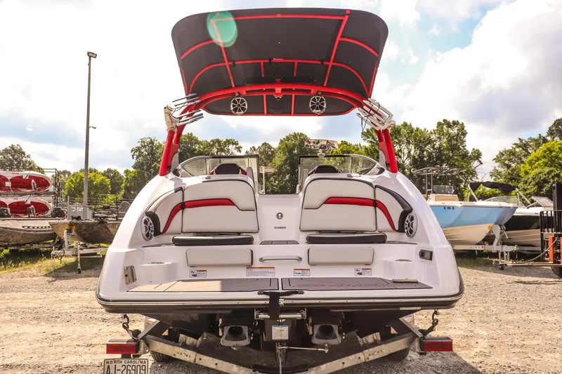 Slide: The Image of 2019 Yamaha Boats 242X E-Series on trailer, rear view, with vibrant red accents. - 5