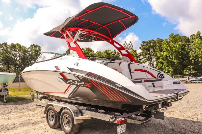 Slide: The Image of 2019 Yamaha Boats 242X E-Series on trailer, featuring sleek design and vibrant red accents. - 6