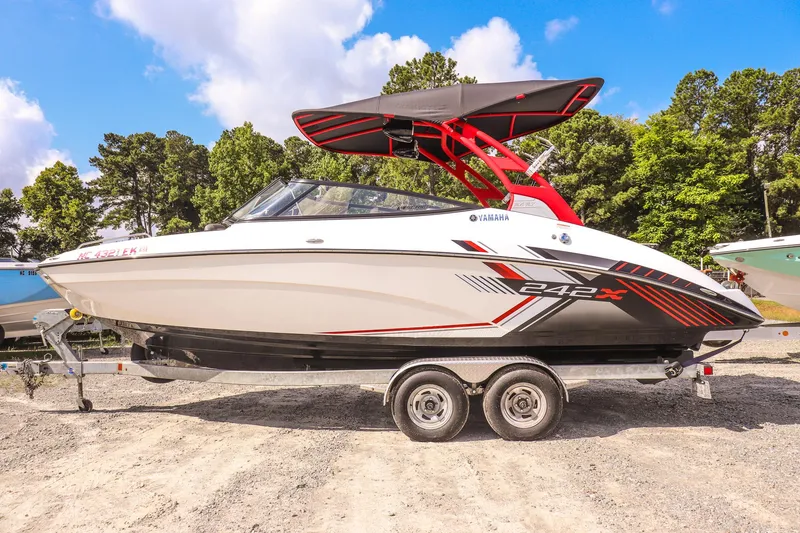 Slide: The Image of 2019 Yamaha Boats 242X E-Series on trailer, featuring sleek design and vibrant graphics. - 7