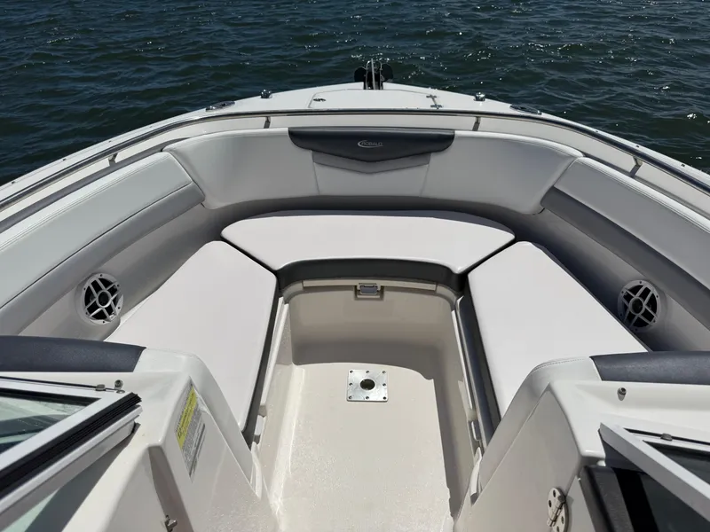 Slide: The Image of 2021 Robalo R247 boat interior with cushioned seating and ocean view. - 12