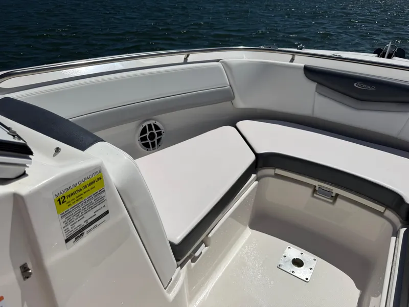 Slide: The Image of 2021 Robalo R247 boat interior with seating, capacity label, and ocean view. - 13