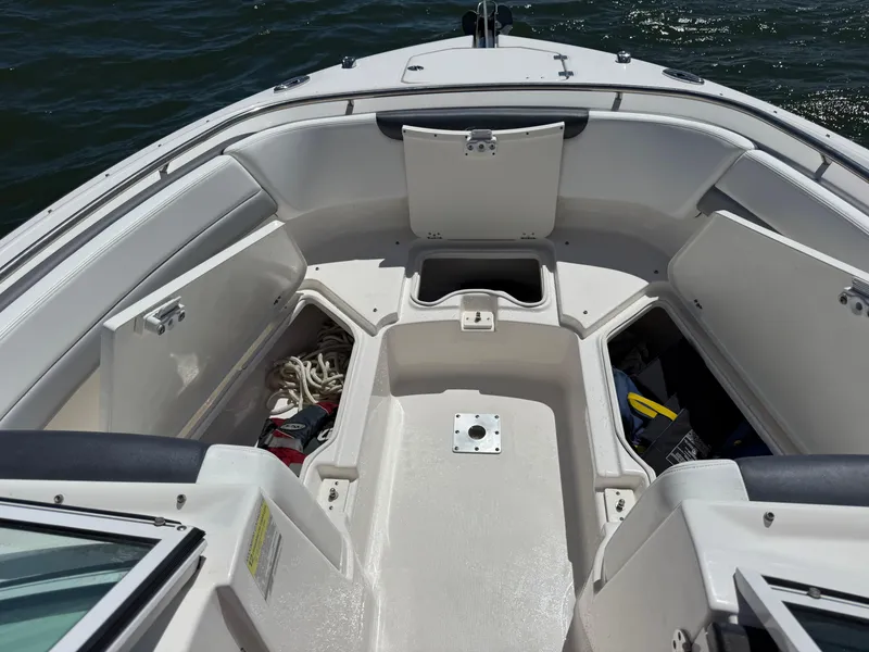Slide: The Image of 2021 Robalo R247 boat interior with open storage compartments on the water. - 19