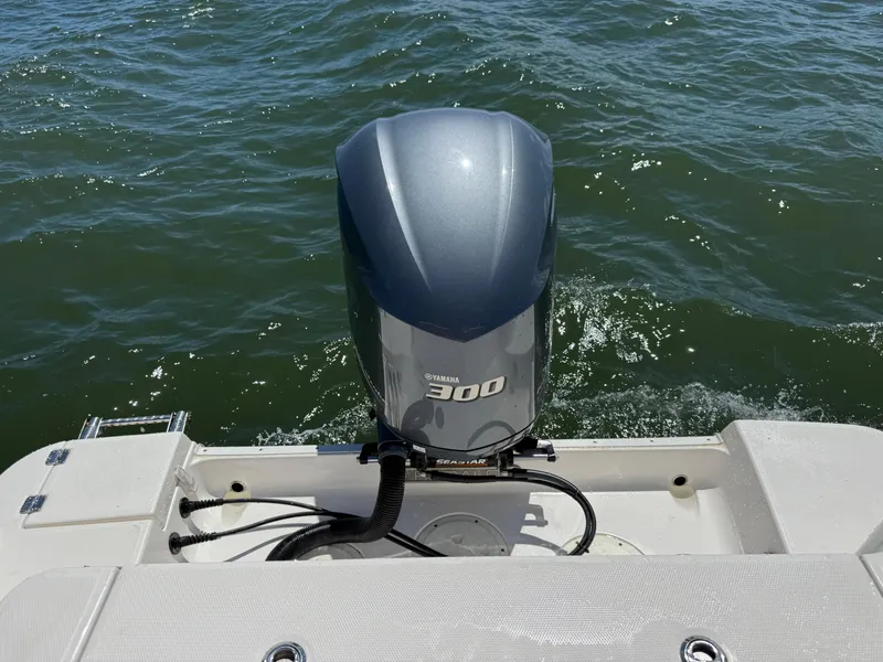 Slide: The Image of 2021 Robalo R247 boat with Yamaha 300 outboard motor on water. - 27