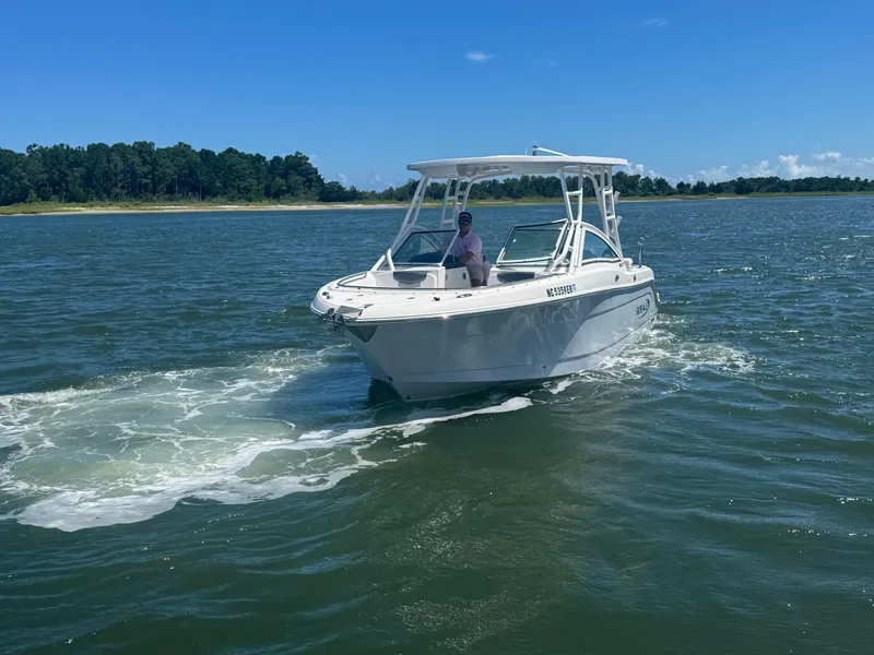 Slide: The Image of 2021 Robalo R247 boat cruising on a sunny day in open water. - 3