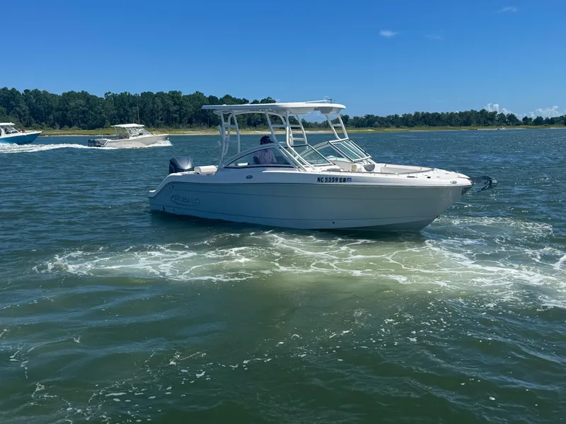 Slide: The Image of 2021 Robalo R247 boat cruising on a sunny day in open water. - 5