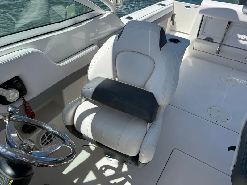 Slide: The Image of 2021 Robalo R247 boat interior with steering wheel and captain's chair. - 8