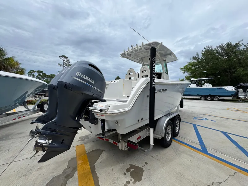 Slide: The Image of 2022 Sailfish 272 CC boat with Yamaha engine on trailer, parked outdoors. - 11