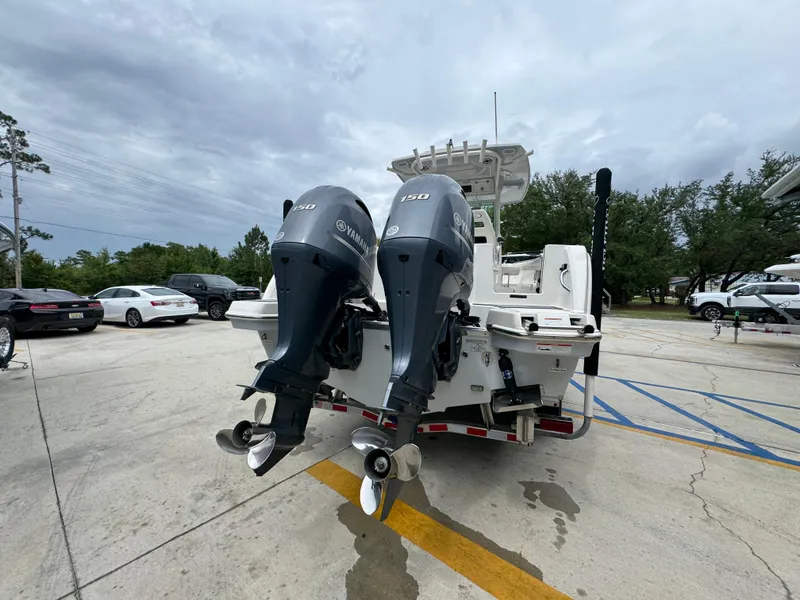 Slide: The Image of 2022 Sailfish 272 CC boat with dual Yamaha outboard motors in a parking lot. - 12