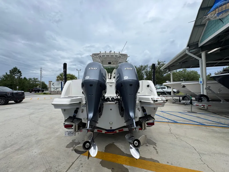 Slide: The Image of 2022 Sailfish 272 CC boat with dual Yamaha 150 engines in a parking lot. - 13