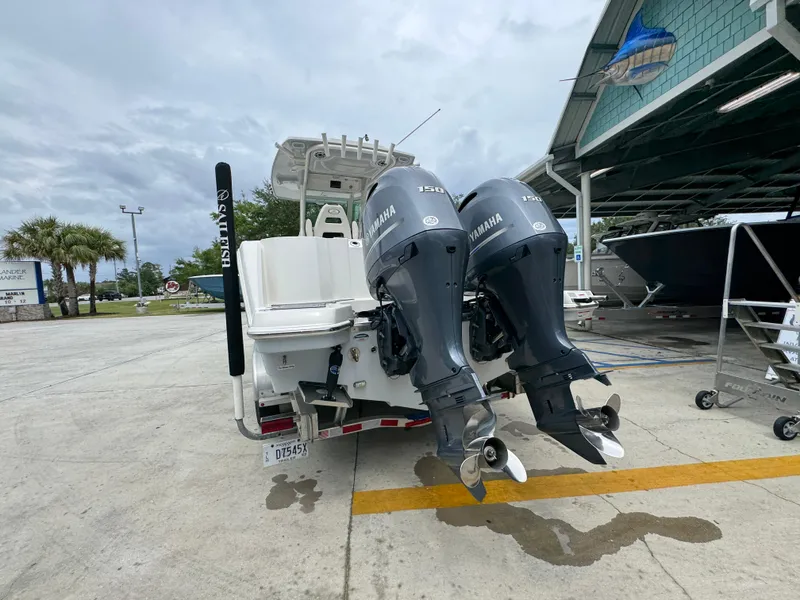 Slide: The Image of 2022 Sailfish 272 CC boat with dual Yamaha outboard engines at a marina. - 14
