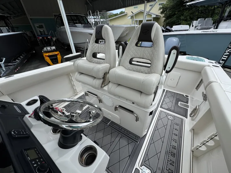 Slide: The Image of 2022 Sailfish 272 CC boat interior with dual seats and modern steering wheel. - 25