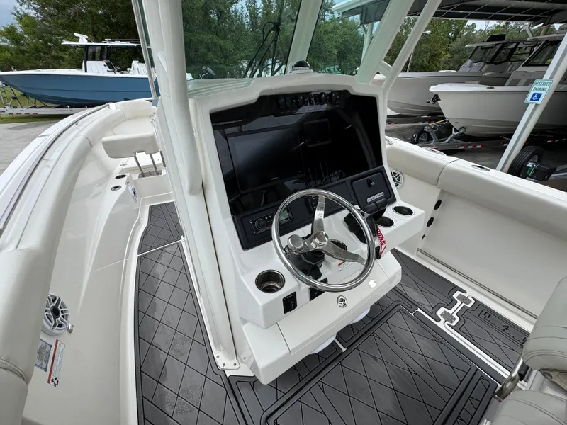 Slide: The Image of 2022 Sailfish 272 CC boat interior with steering wheel and control panel. - 27