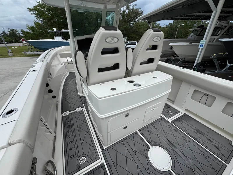 Slide: The Image of 2022 Sailfish 272 CC boat interior with dual seats and storage compartments. - 29