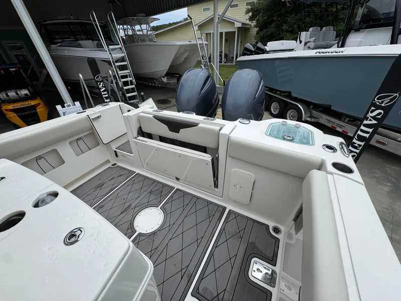 Slide: The Image of 2022 Sailfish 272 CC boat interior with dual engines and modern deck design. - 31