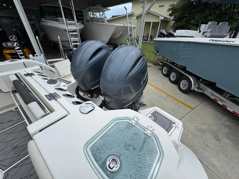 Slide: The Image of 2022 Sailfish 272 CC boat with dual Yamaha outboard engines in a showroom. - 33