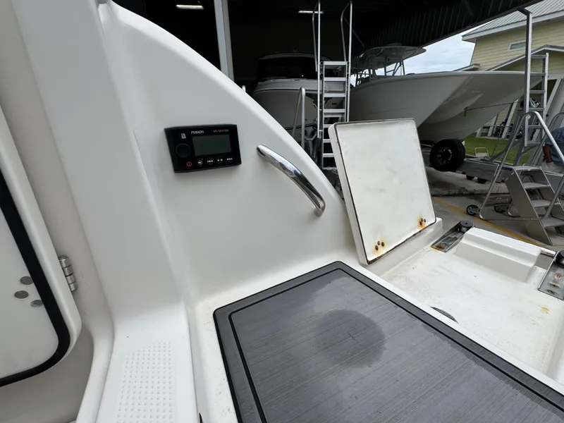 Slide: The Image of 2022 Sailfish 272 CC boat interior with control panel and storage compartment. - 35