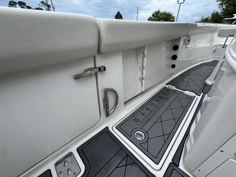 Slide: The Image of 2022 Sailfish 272 CC boat interior with cushioned seating and non-slip flooring. - 36