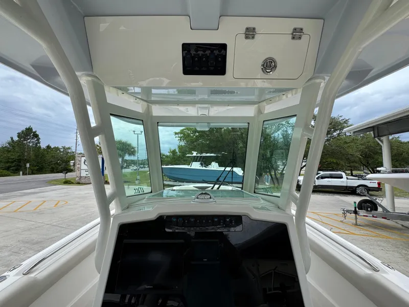 Slide: The Image of 2022 Sailfish 272 CC boat interior with dashboard and windshield view. - 37