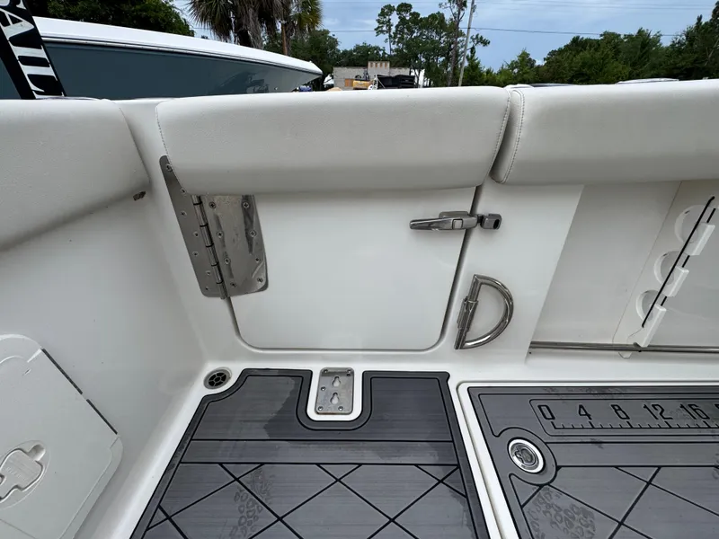 Slide: The Image of 2022 Sailfish 272 CC boat interior with cushioned seating and deck details. - 38