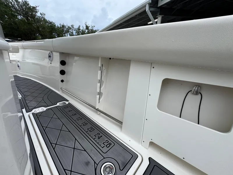 Slide: The Image of 2022 Sailfish 272 CC boat interior with storage compartments and non-slip flooring. - 39