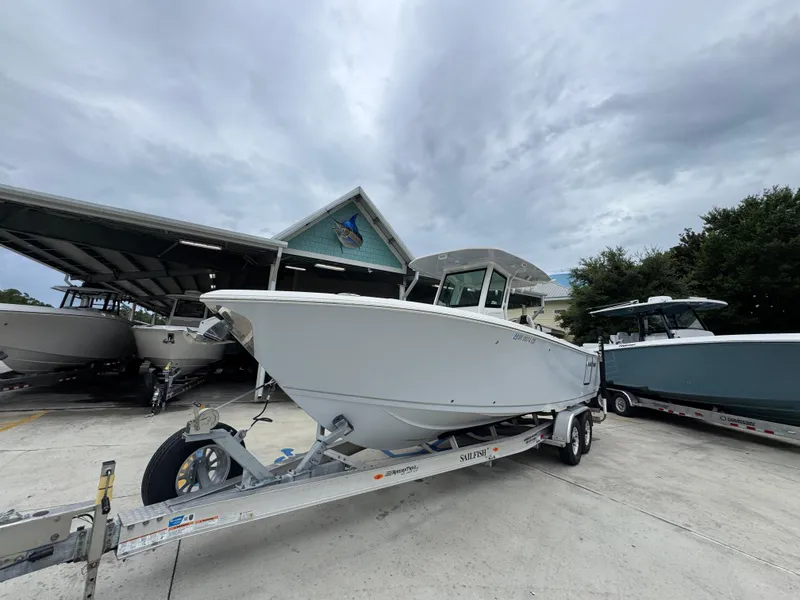 Slide: The Image of 2022 Sailfish 272 CC boat on trailer, parked outdoors under cloudy sky. - 4