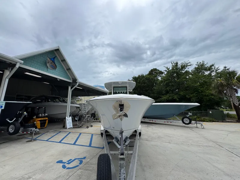 Slide: The Image of 2022 Sailfish 272 CC boat on trailer at marina, cloudy sky background. - 6