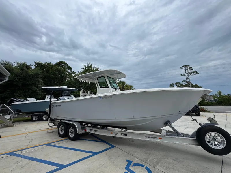 Slide: The Image of 2022 Sailfish 272 CC boat on trailer, parked outdoors under cloudy sky. - 8