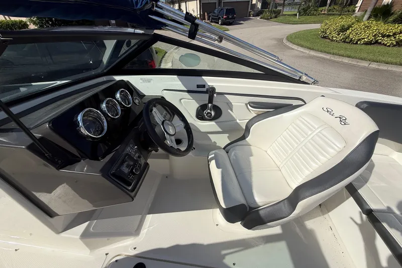 Slide: The Image of 2018 Sea Ray SPX 190 boat interior with steering wheel and branded seat. - 10