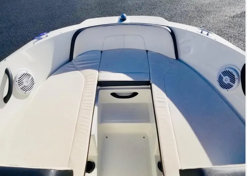 Slide: The Image of 2018 Sea Ray SPX 190 boat interior with cushioned seating and built-in speakers. - 15