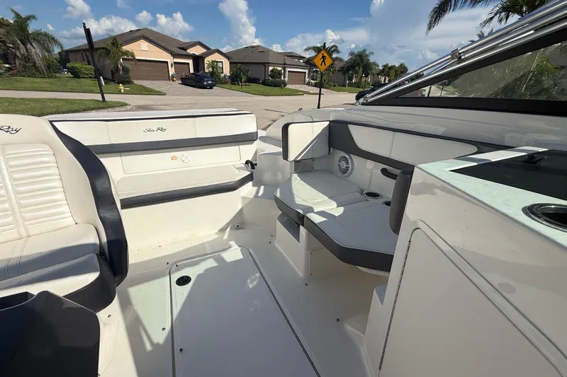 Slide: The Image of 2018 Sea Ray SPX 190 boat interior with seating and cup holders. - 17