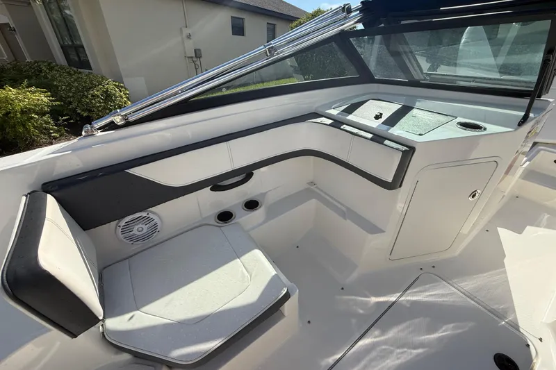 Slide: The Image of 2018 Sea Ray SPX 190 boat interior with seating and storage compartments. - 2