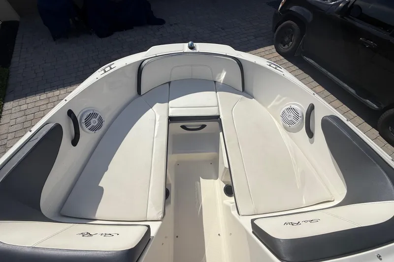 Slide: The Image of 2018 Sea Ray SPX 190 boat interior with white seating and built-in speakers. - 20