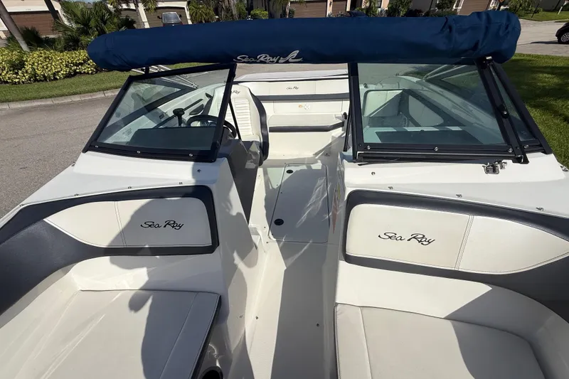 Slide: The Image of 2018 Sea Ray SPX 190 boat interior with blue canopy and sleek design. - 23