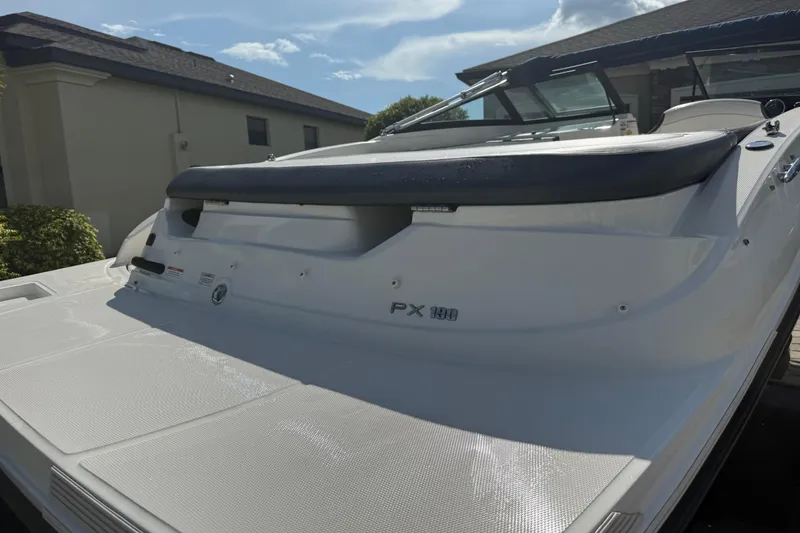 Slide: The Image of 2018 Sea Ray SPX 190 boat, rear view, parked outdoors under a clear sky. - 26