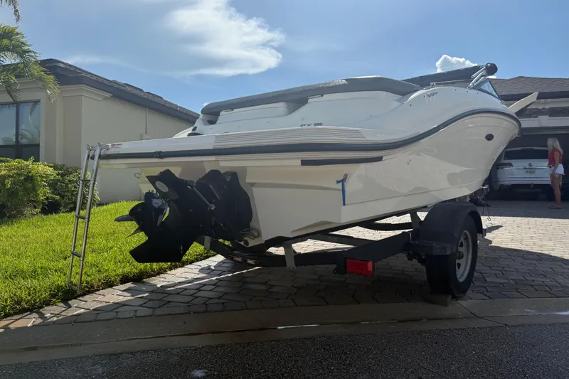 Slide: The Image of 2018 Sea Ray SPX 190 boat on trailer, parked in a residential driveway. - 4
