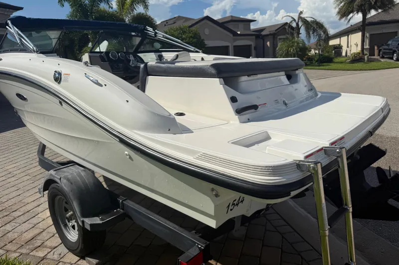 Slide: The Image of 2018 Sea Ray SPX 190 boat on trailer, parked in residential area. - 5