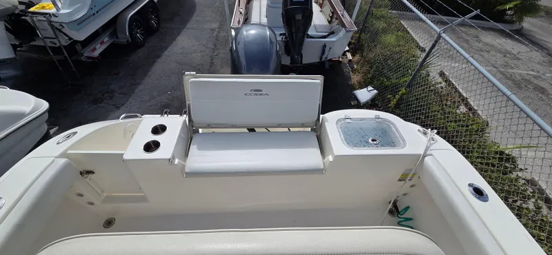 Slide: The Image of 2023 Cobia 220 Center Console boat interior with seating and livewell. - 11