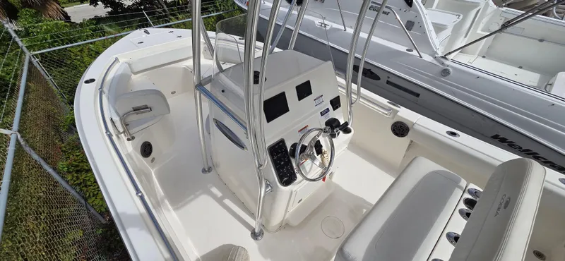Slide: The Image of 2023 Cobia 220 Center Console boat interior with steering wheel and seating. - 16