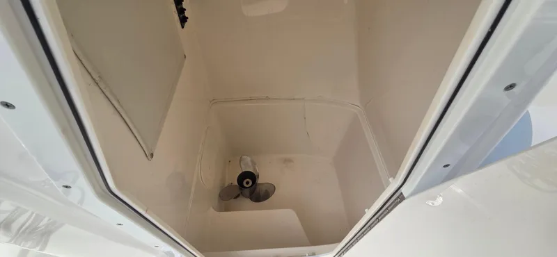 Slide: The Image of 2023 Cobia 220 Center Console storage compartment with propeller inside. - 4