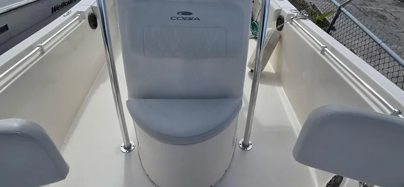 Slide: The Image of 2023 Cobia 220 Center Console boat interior with seating and railings. - 8