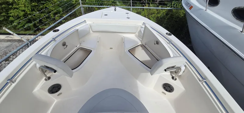 Slide: The Image of 2023 Cobia 220 Center Console boat interior with seating and storage compartments. - 9