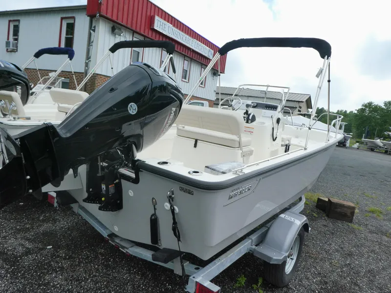 Slide: The Image of 2025 Boston Whaler 170 Montauk boat on trailer, parked outdoors. - 2