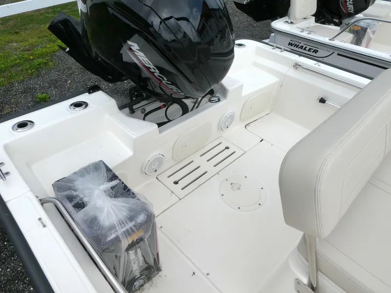 Slide: The Image of 2025 Boston Whaler 170 Montauk boat interior with Mercury engine and seating area. - 3