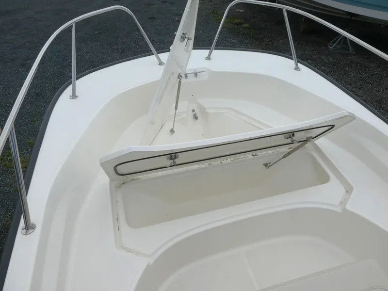 Slide: The Image of 2025 Boston Whaler 170 Montauk boat with open storage compartment on deck. - 7