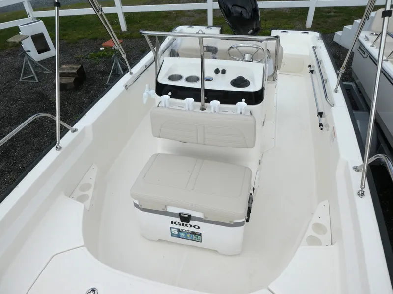 Slide: The Image of 2025 Boston Whaler 170 Montauk boat interior with seating and console, featuring Igloo cooler. - 9