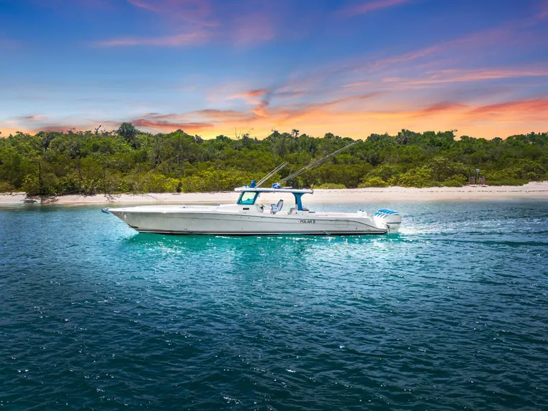 The Image of 2020 HCB 53 boat cruising near a tropical shoreline at sunset. - 0
